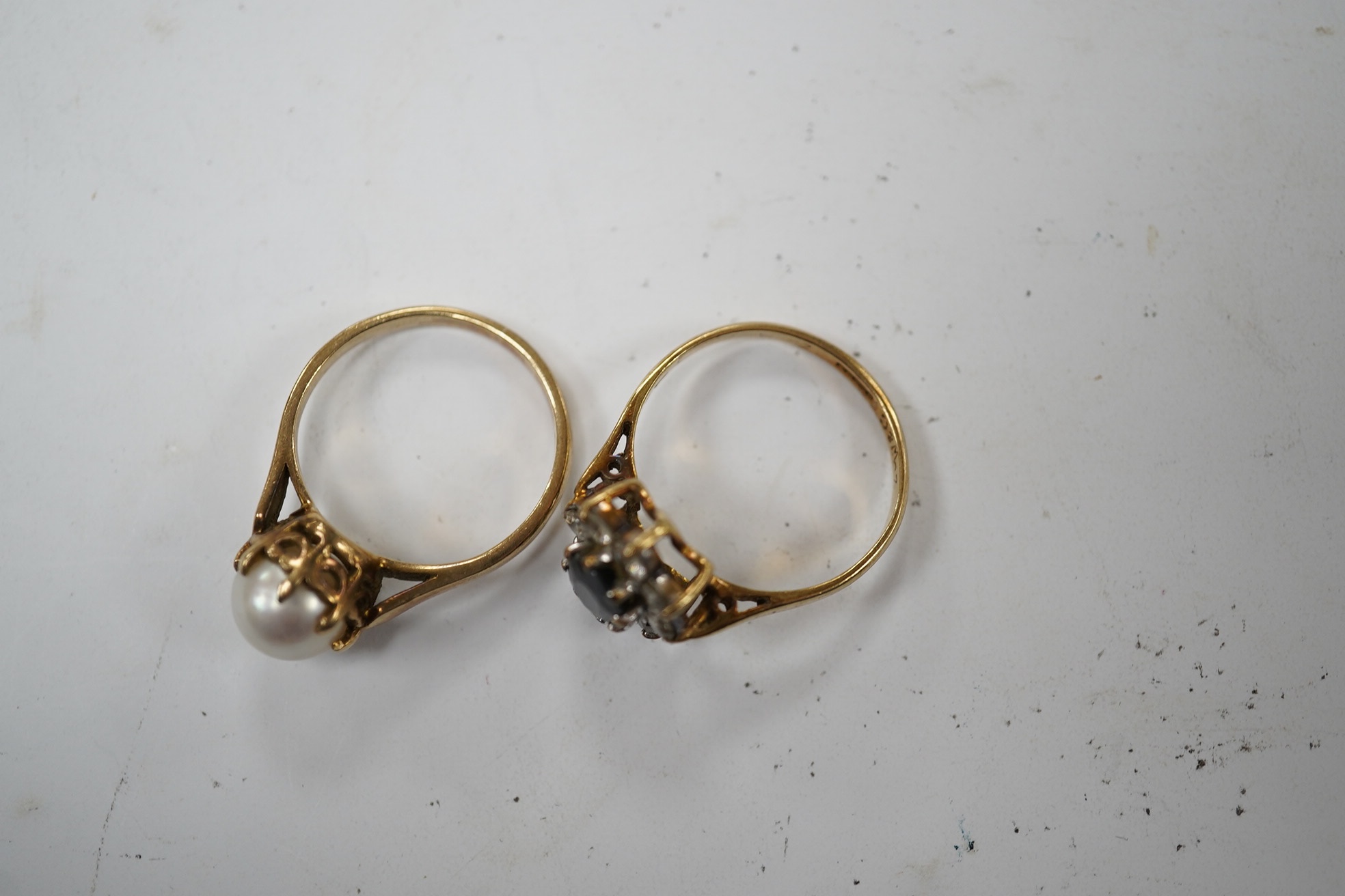 A 9ct gold, sapphire and simulated diamond cluster set ring, size M and a 9ct gold and cultured pearl set ring, gross weight 5 grams. Condition - fair